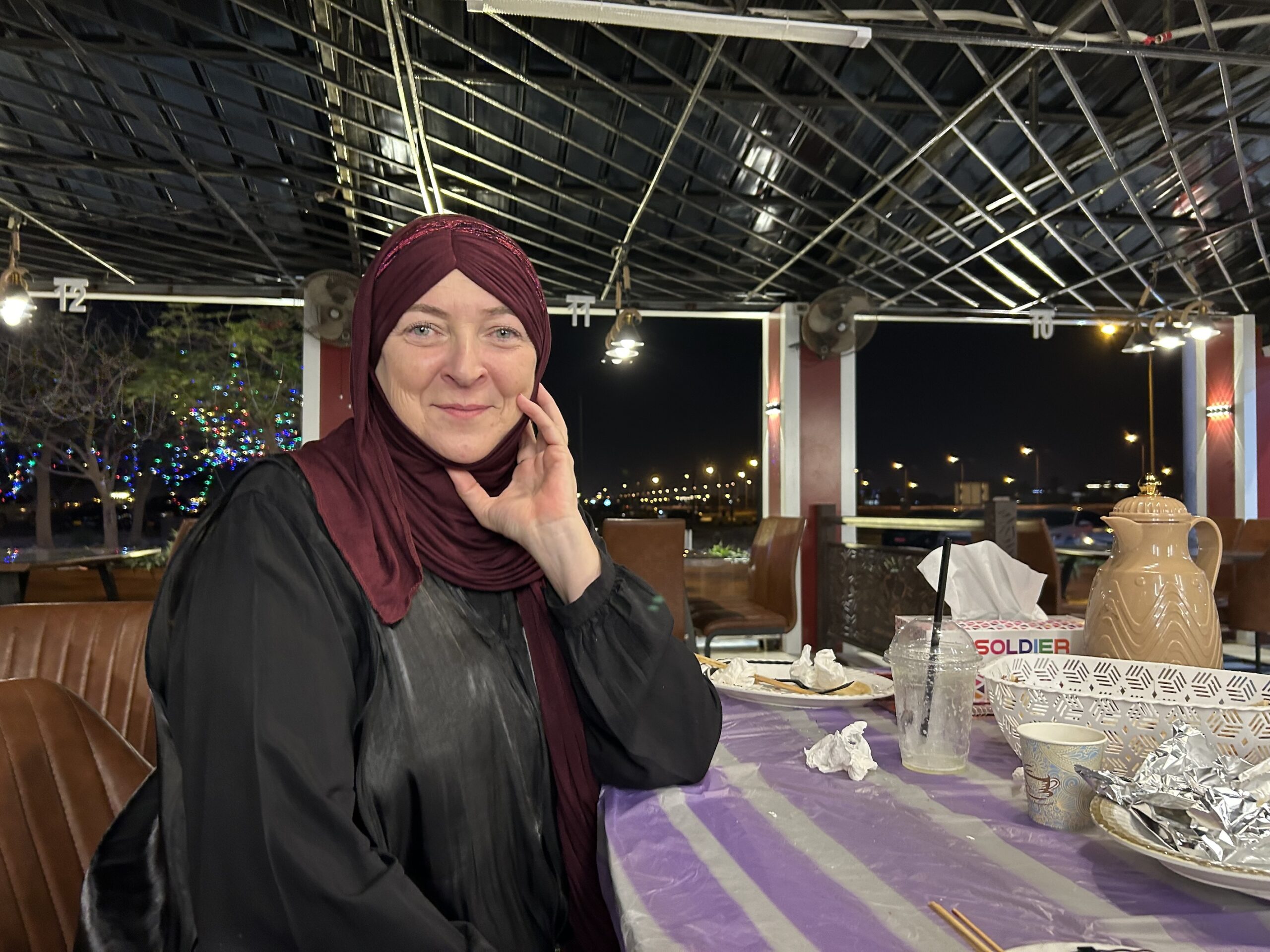 Woman in Oman with veil in a restaurant